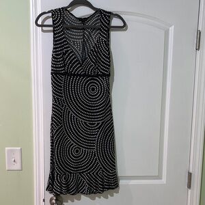 Black spotted cocktail dress with black lace trim under the chest.